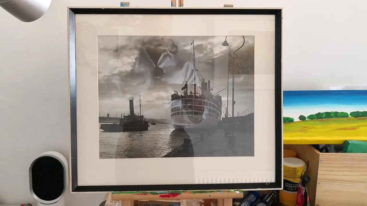 Large black-and-white maritime print in a wide black frame propped in the workshop
